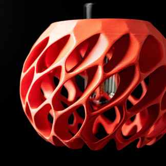 Detailed close-up of a modern 3D printed LED lamp in vibrant red.