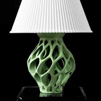 Intricate green 3D-printed lamp with lattice design, showcasing innovative additive manufacturing from AM Square 3D.