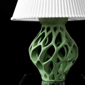 Bright white lampshade atop a unique green lattice ceramic base. Perfect for modern lighting décor.