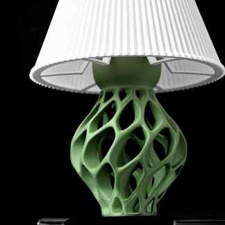Detailed green 3D printed lamp base with modern design on black background.