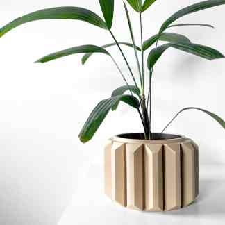 Bright white 3D printed geometric planter with a green houseplant on a white background.