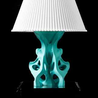 This 3D-printed lamp features a unique, artistic turquoise base with a classic white fabric lampshade.