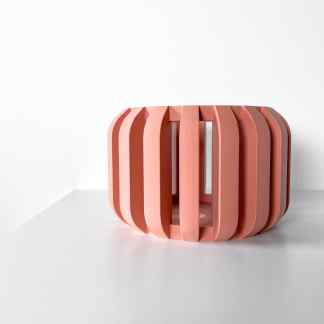 Sleek, pink 3D-printed geometric sculpture with contemporary design on white background.