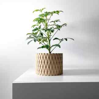 A stylish 3D printed plant pot with a contemporary geometric design, featuring a healthy green plant, showcased by AM Square 3D.