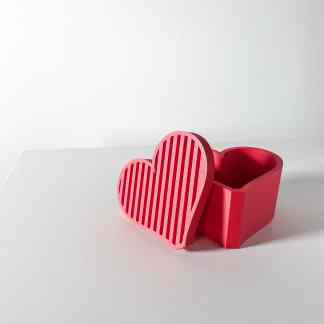 Bright pink 3D printed heart jewelry box on white surface, modern gift idea, Valentine's Day decor.