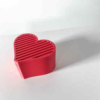 Bright pink 3D-printed heart with slats, showcasing creative digital fabrication.