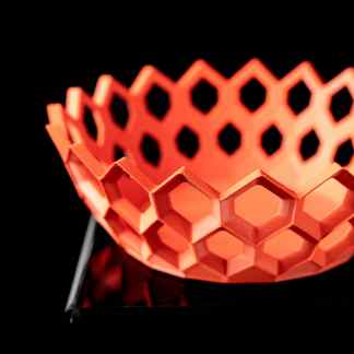 High-quality orange 3D printed filament holder with honeycomb design for filament organization.