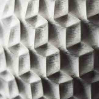 Close-up of 3D printed hexagonal geometric structure on industrial surface.