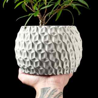 3D printed flower pot showcasing intricate geometric patterns, perfect for modern home decor.