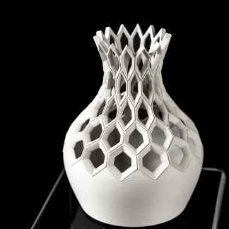 Highly detailed 3D-printed vase with a geometric honeycomb design, showcasing innovative additive manufacturing technology.