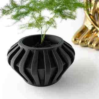 Black 3D printed flowerpot with ribbed geometric design for stylish home or office decor.