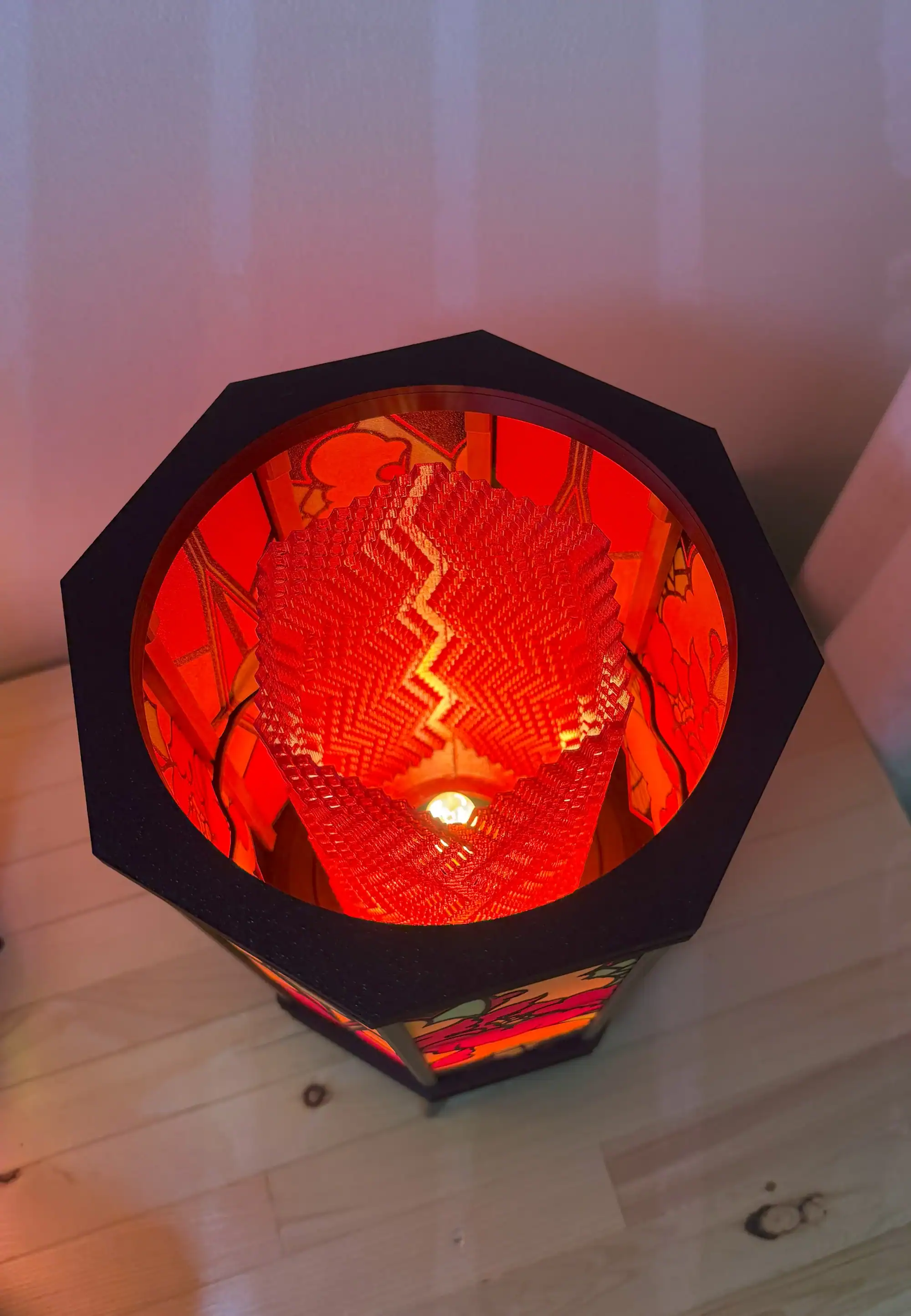 Bright red 3D-printed lantern with artistic geometric patterns and LED light inside.