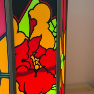 Bright LED stained glass lamp with intricate floral pattern in red, yellow, and green hues.