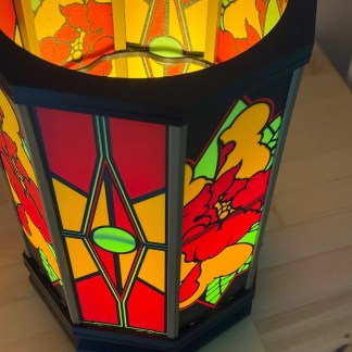 Bright stained glass table lamp showcasing red, yellow, and green floral patterns for elegant ambiance.