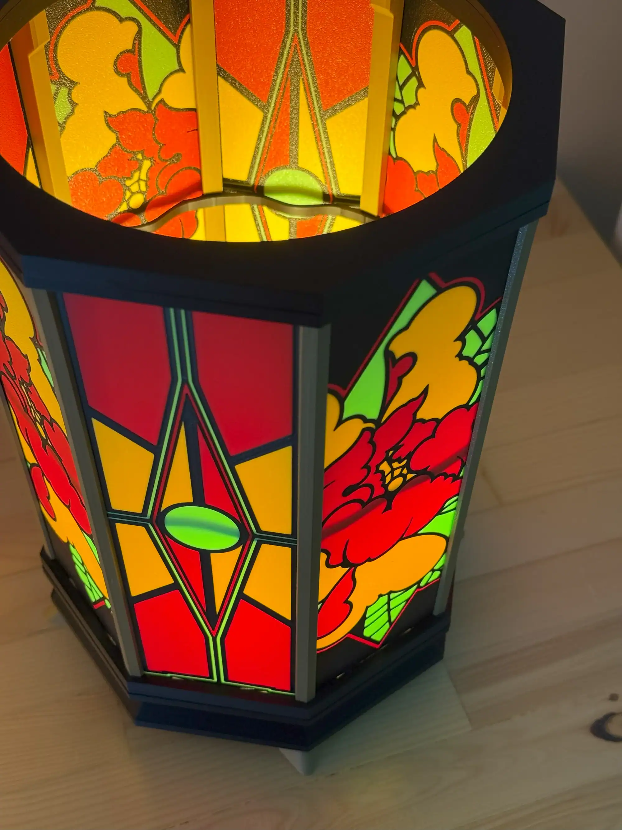Bright stained glass table lamp showcasing red, yellow, and green floral patterns for elegant ambiance.