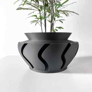 Modern 3D printed black plant pot with curved geometric design perfect for home decor.