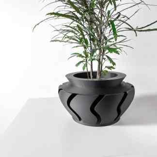 High-quality 3D printed black vase with unique cutout patterns, ideal for contemporary flower displays and interior accents.