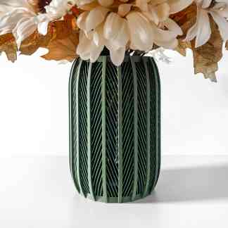 Modern 3D-printed green vase with intricate linear patterns, holding white and brown floral arrangement.