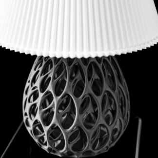 Detailed 3D-printed lamp with innovative lattice pattern on a black background.
