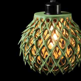 A modern, eco-friendly 3D-printed lampshade with intricate lattice patterns and warm lighting.