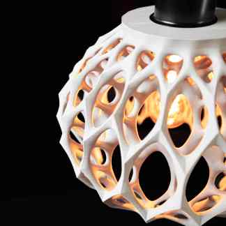 3D printed geometric lamp with warm glow, modern decor, innovative printing tech.