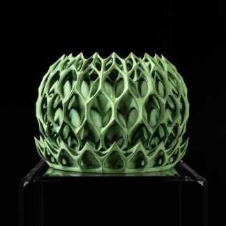 Intricate 3D printed green sculpture with honeycomb design for modern art and decor.