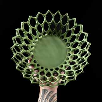 Highly detailed 3D-printed geometric lattice in vibrant green, showcasing advanced 3D printing technology.