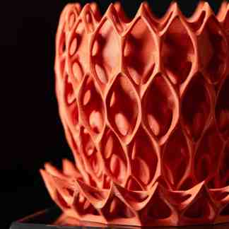 Intricate 3D printed artistic sculpture with complex lattice structure, demonstrating advanced additive manufacturing.