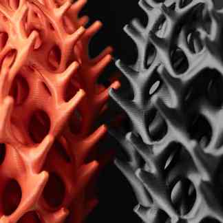 Detailed close-up of orange and gray 3D printed lattice designs.