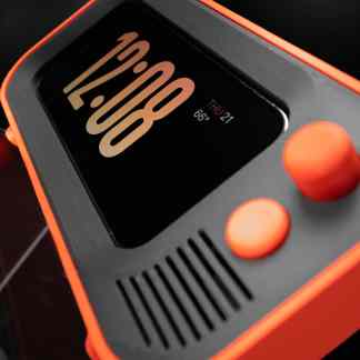 Close-up of a modern smartwatch with a sleek digital display and vibrant orange accents.