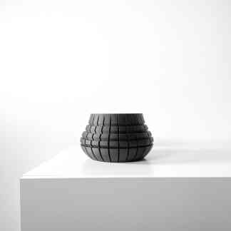 Modern black 3D-printed abstract sculpture.