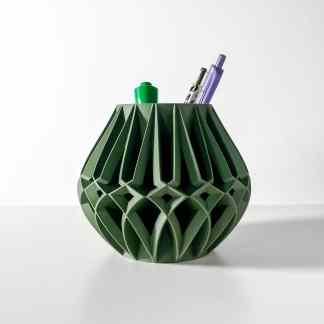 A modern green 3D-printed pen holder with geometric, lattice-like structure and stationery tools inside.