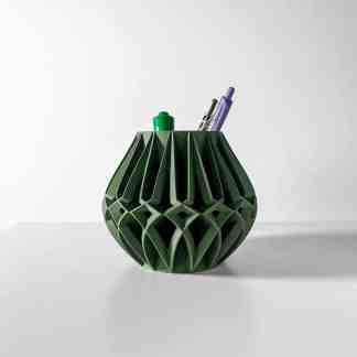 Stylish 3D-printed green geometric pen holder with pens and markers. Ideal for desk organization and modern decor.