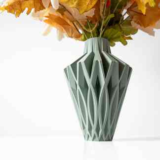 Vase with a unique textured geometric pattern filled with autumn-themed artificial flowers for stylish home decoration.
