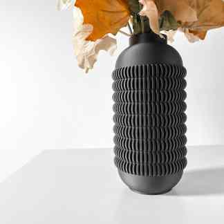 Stylish black 3D-printed vase with textured, ribbed exterior, ideal for modern home decor and floral arrangements.