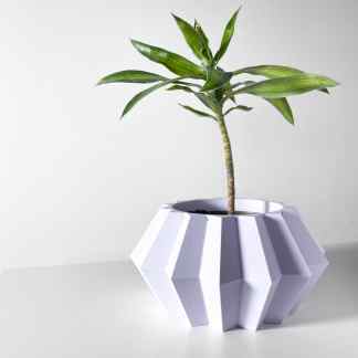 3D printed white geometric flower pot with a green plant, showcasing modern design and 3D printing craftsmanship.