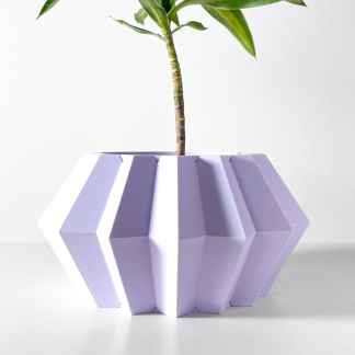 3D printed plant pot with geometric design and green plant for home decor.