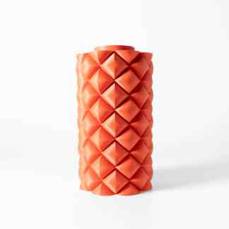 Bright orange 3D-printed vase with a textured geometric design on a white background.