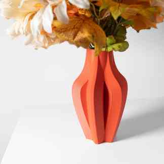 Vibrant orange 3D-printed ceramic vase holding artificial flower arrangement for stylish home decoration.
