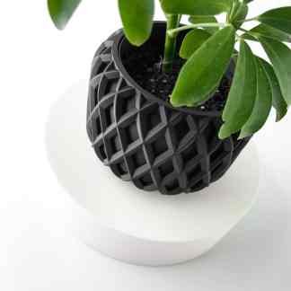 Stylish 3D-printed black geometric plant pot showcasing innovative interior decor designs.