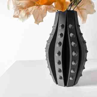 Unique 3D-printed black and gray vase with textured round patterns for stylish home decoration.