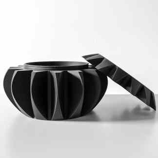 3D printed black container with lid, highlighting advanced additive manufacturing technology and sleek aesthetics.