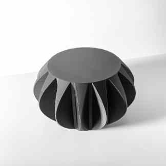 Sharp-edged 3D printed sculpture with modern metallic finish, showcasing innovative design elements.