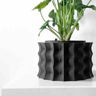 Stylish black 3D printed planter with wave pattern, perfect for modern home decor and plant display.