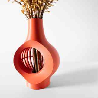 Vibrant orange 3D printed vase with a hollow geometric design, showcasing modern craftsmanship for home decor.