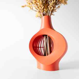 Close-up of a stylish, orange 3D-printed vase holding dried flowers, showcasing innovative 3D printing design.