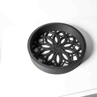 Black 3D-printed lotus pattern coaster for home or office decor.