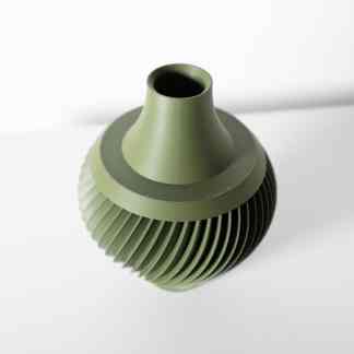 Detailed green 3D-printed fan component with fine ridges and precise design.