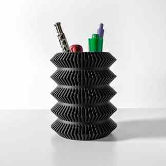 Stylish black 3D-printed pen holder with colorful pens, highlighting innovative design and modern craftsmanship.