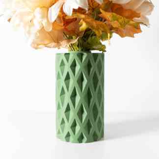 Vase showcasing intricate 3D printing design in green, holding a bouquet of flowers for stylish home decoration.